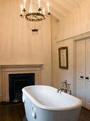 Traditional bathroom with fireplace and free-standing antique bathtub