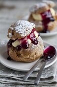 Profiteroles filled with vanilla cream and blueberry jam