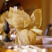 Christmas present with ribbon on festive table
