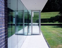 House with glass wall leading to terrace