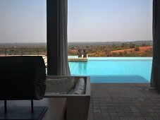 View of pool and Indian landscape from roofed terrace