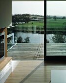 View of surrounding landscape from living room across balcony