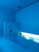 Dive into the blue - azure blue bathroom with sunken bathtub