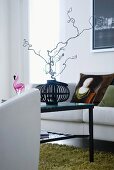 Colorful flora and fauna pattern on a black background on the wall and armchair