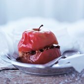 A baked apple filled with raisins and chopped nuts