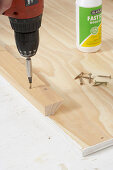 Attaching wooden batten to panel using cordless screwdriver