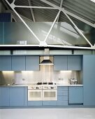 Light-grey fitted kitchen in loft apartment