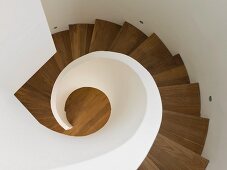 Top view of wooden spiral staircase with white balustrade