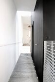Corridor with black walls & wire mesh floor