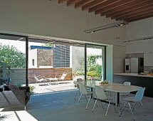 View through large window in dining area of balcony and adjacent house