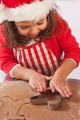 Little girl cutting out gingerbread men