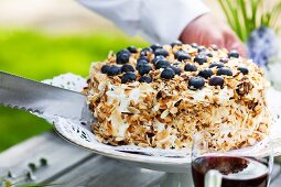 Slicing blueberry torte