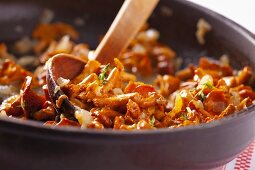 Fried chanterelle mushrooms with onions in a pan