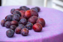 Fresh plums on a garden table