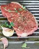 A seasoned steak on a grill