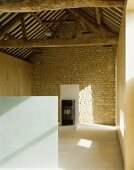 View of rustic roof timbers in renovated and modernised farmhouse