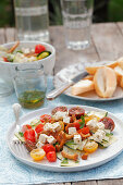 A chanterelle mushroom, tomato and courgette salad with feta cheese