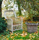 Weathered rattan armchair and basket on lawn