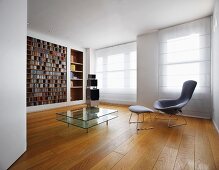 Minimalist room with classic armchair and footstool