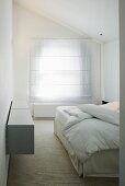 White bedroom with closed blinds on window