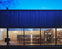 House at twilight with illuminated interior and view of dining area