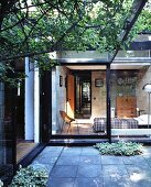 Terrace with view of sunny bedroom through sliding glass wall