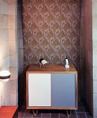 Small sideboard in niche against patterned fabric