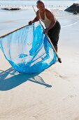 A Burman fishing for mini prawns