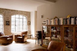 Comfortable living room with leather armchairs in former factory