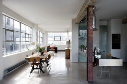 Vintage-style dining area and designer kitchen in loft apartment