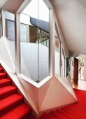 Staircase with red carpet in contemporary apartment building with futuristic ambiance