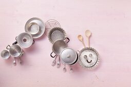 Pots and baking tins arranged in a caterpillar