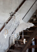 Paper-wrapped biscuit cutters hanging from lampshade