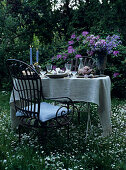 Garden table romantically set with candles and flowers