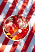 Ice cream with redcurrants and peaches