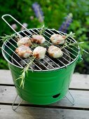 Grilled scallops wrapped in bacon with rosemary