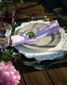 A place setting with a checked napkin