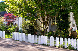 View of front garden of house with low picket fence