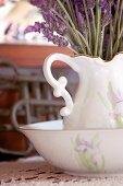 Close up of a porcelain pitcher with lavender flowers