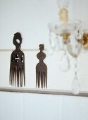 Ethnic-style decorated wooden combs hung on wall