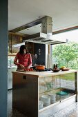 Teenager preparing food on kitchen island in open-plan kitchen