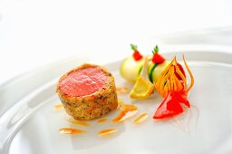 Lamb fillet in a mushroom crust with courgette ratatouille cannelloni, red artichoke and piquillo peppers
