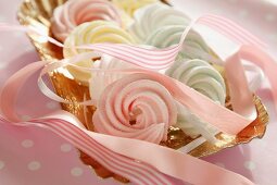 Pastel-coloured meringues with pink ribbons