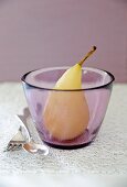 A poached pear in a glass