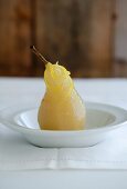 A poached pear with lemon zest