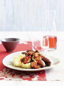 Sausages with tomato and courgette sauce and mashed potatoes