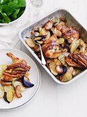 Roast chicken breast wrapped in bacon with apples and potatoes