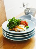 Fried eggs with garlic and herb crumbs and a salad garnish