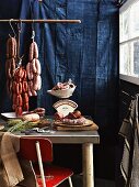 Various types of sausages hanging on butchers hooks