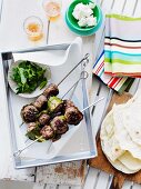 Grilled ground lamb kebabs with flat bread